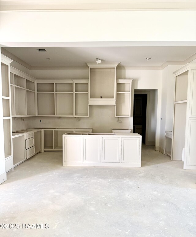 kitchen featuring a kitchen island and unfinished concrete floors