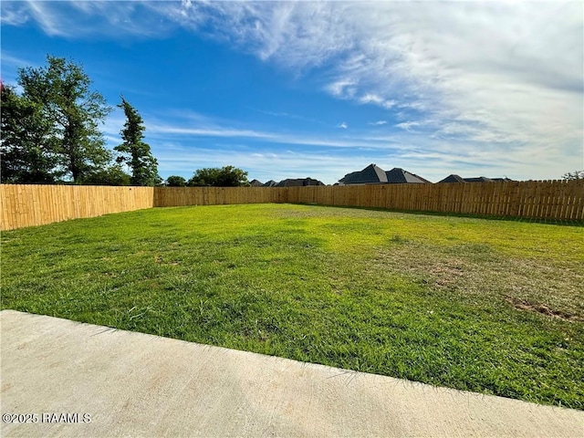 view of yard with a fenced backyard