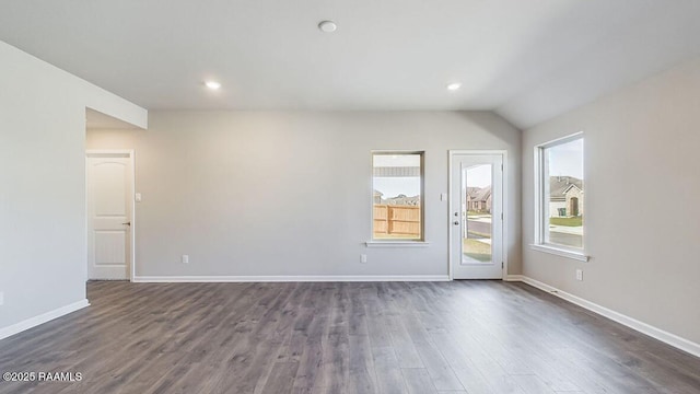 empty room with dark wood-type flooring, recessed lighting, and baseboards
