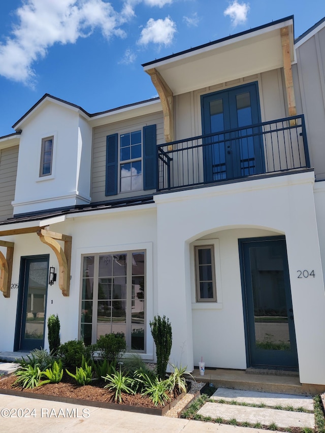 115 Gaunt Ln Unit 705, Youngsville, LA 70592 - view of front of home featuring a standing seam roof, a balcony, and stucco siding