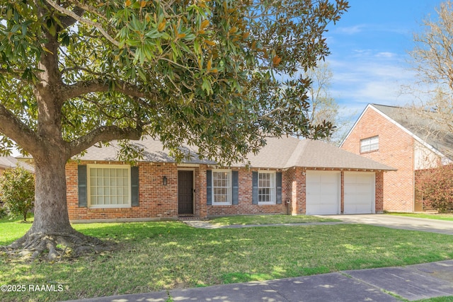 view of front of property with roof with shingles, concrete driveway, a front lawn, a garage, and brick siding