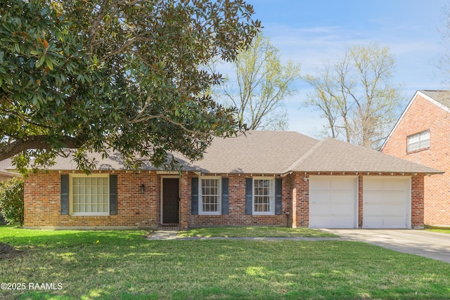 single story home featuring a front yard, concrete driveway, brick siding, and a garage