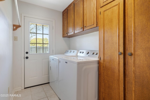 washroom with light tile patterned floors, baseboards, cabinet space, and independent washer and dryer