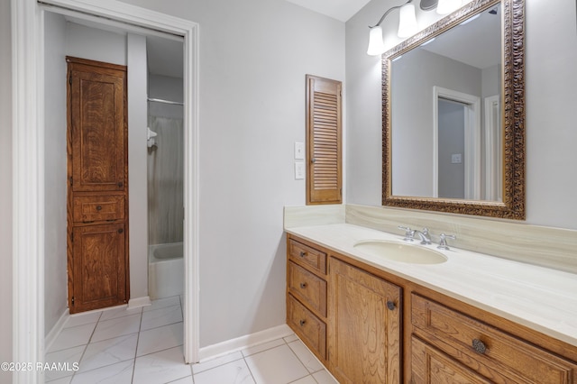 bathroom with vanity,  shower combination, and baseboards