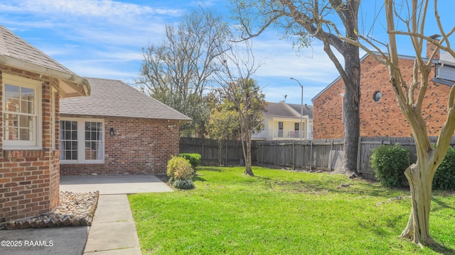 view of yard featuring a patio and fence