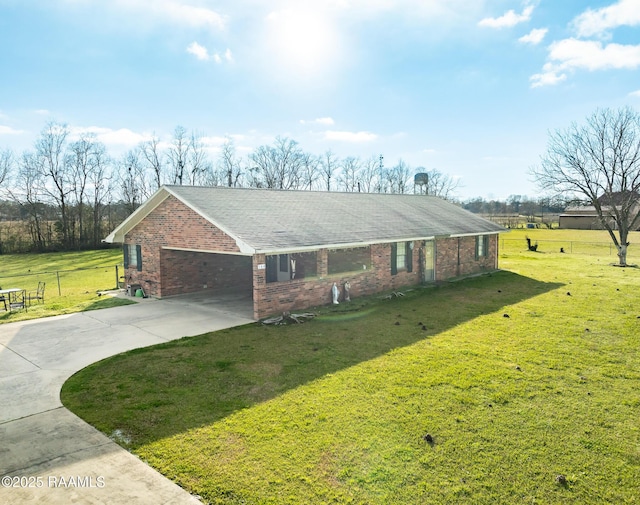 view of front of house with brick siding, a shingled roof, concrete driveway, and a front yard