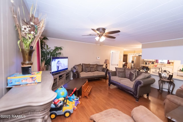 living area with ceiling fan and wood finished floors