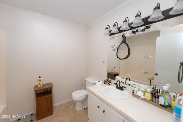 bathroom featuring baseboards, crown molding, vanity, and toilet