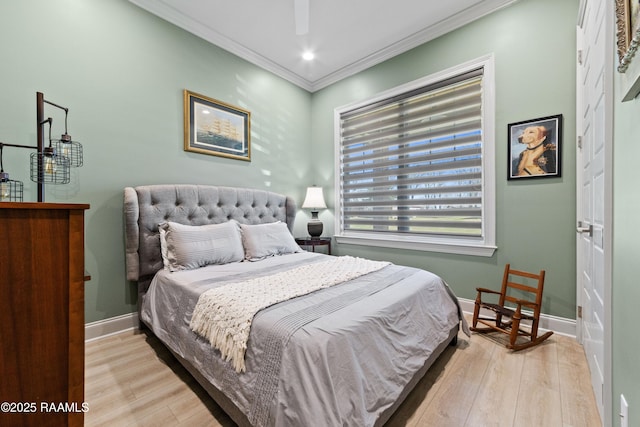 bedroom with light wood-type flooring, crown molding, and baseboards