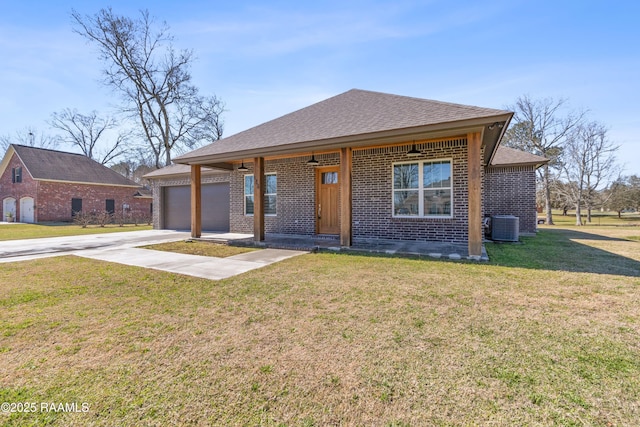 view of front of property featuring driveway, a garage, a front lawn, and brick siding