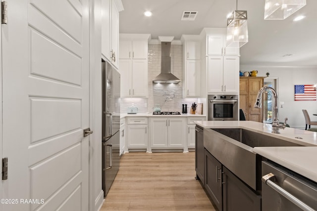 kitchen featuring white cabinets, appliances with stainless steel finishes, and light countertops