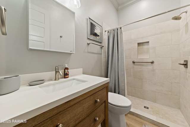 bathroom featuring toilet, a stall shower, ornamental molding, and vanity