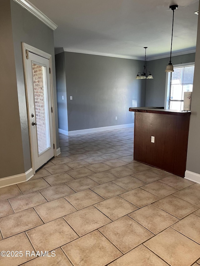 empty room with ornamental molding, a chandelier, light tile patterned flooring, and baseboards