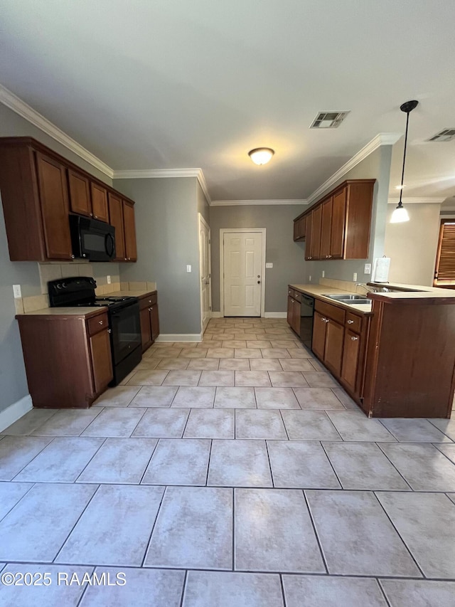 kitchen with black appliances, visible vents, light countertops, and pendant lighting