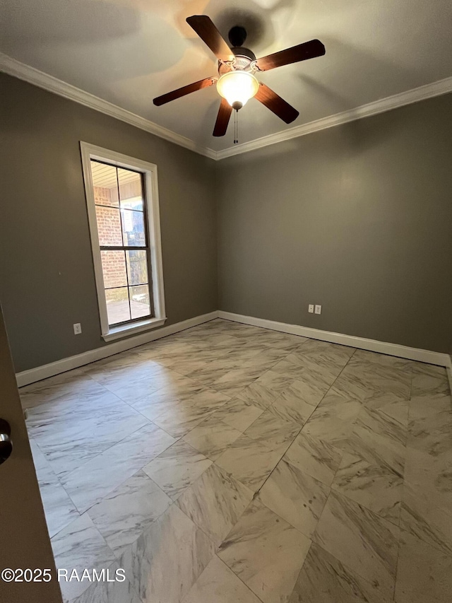 unfurnished room with marble finish floor, baseboards, ornamental molding, and ceiling fan