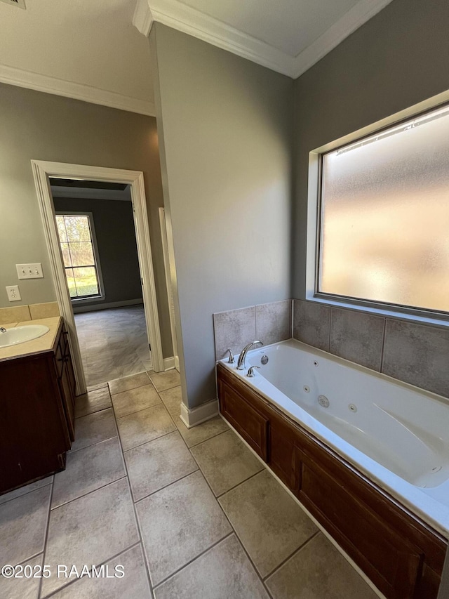 full bathroom featuring a tub with jets, ornamental molding, vanity, and tile patterned floors