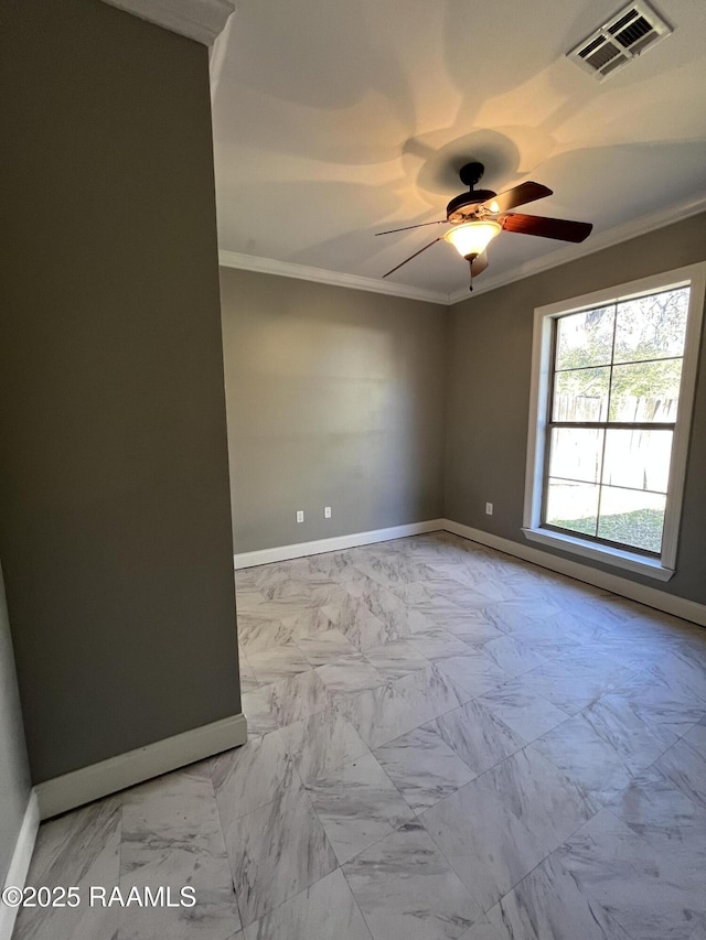 empty room featuring marble finish floor, baseboards, visible vents, and crown molding