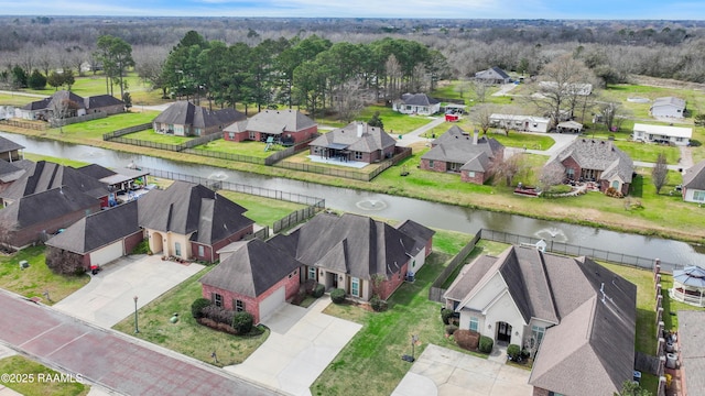 birds eye view of property featuring a water view and a residential view