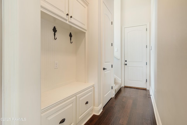 mudroom featuring dark wood-style flooring and baseboards