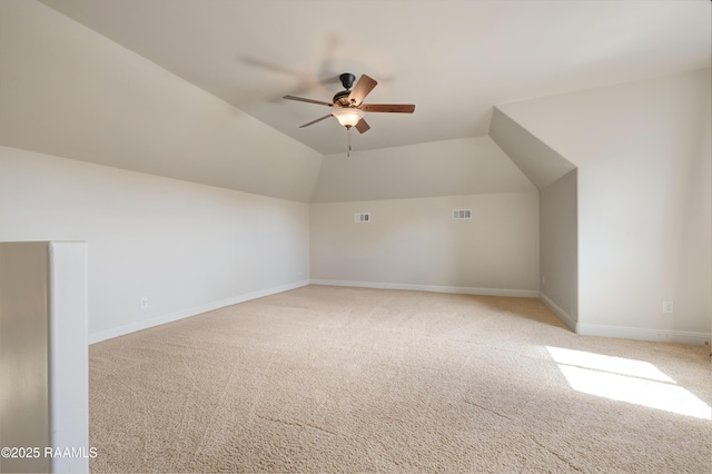 bonus room featuring lofted ceiling, light colored carpet, ceiling fan, and visible vents