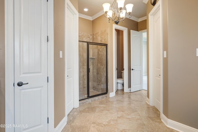 full bathroom with toilet, a notable chandelier, baseboards, ornamental molding, and a shower stall