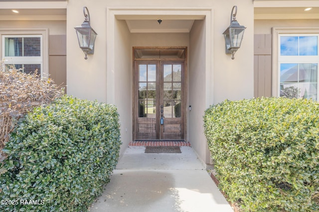 doorway to property featuring french doors and stucco siding