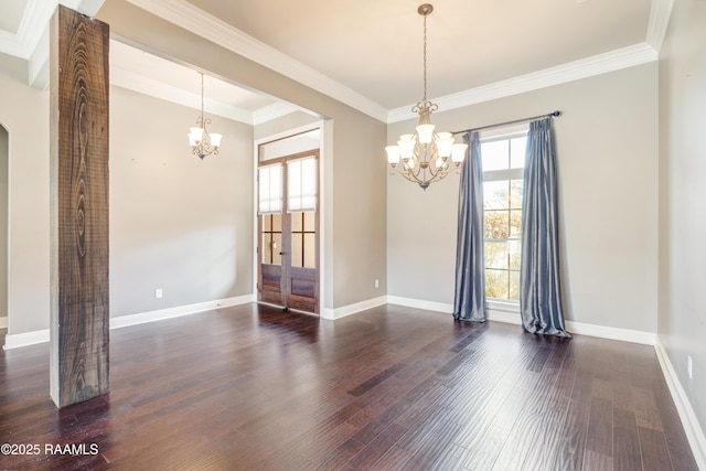 spare room with baseboards, dark wood-style flooring, and a notable chandelier