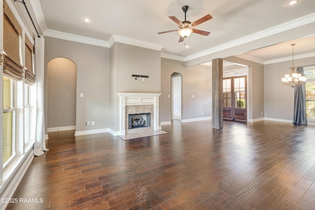 unfurnished living room featuring ornamental molding, dark wood-style flooring, a high end fireplace, and baseboards