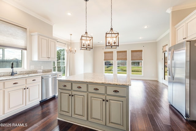 kitchen featuring plenty of natural light, dark wood-style flooring, stainless steel appliances, and a sink