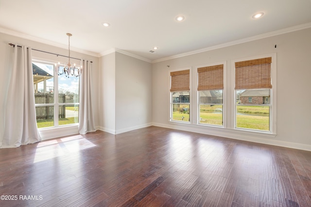 empty room with crown molding, a chandelier, and dark wood-style flooring