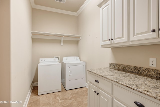 laundry room with visible vents, baseboards, cabinet space, washing machine and clothes dryer, and crown molding