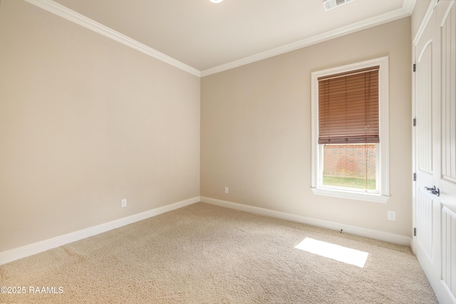 carpeted empty room with ornamental molding, visible vents, and baseboards