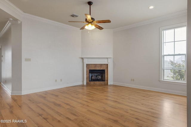 unfurnished living room with light wood-style flooring, a fireplace, visible vents, baseboards, and ornamental molding