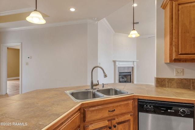 kitchen with decorative light fixtures, crown molding, stainless steel dishwasher, brown cabinetry, and a sink