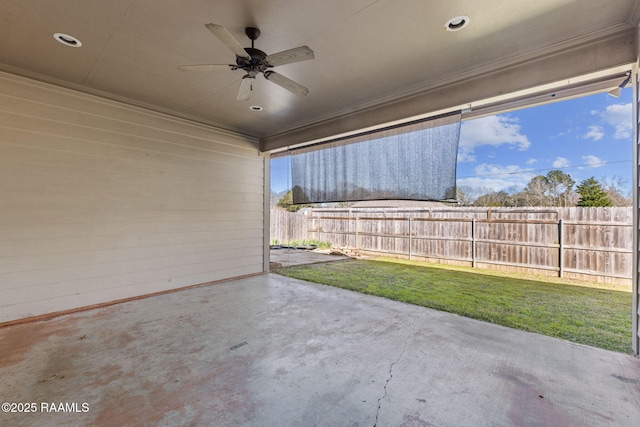 view of patio with ceiling fan and fence