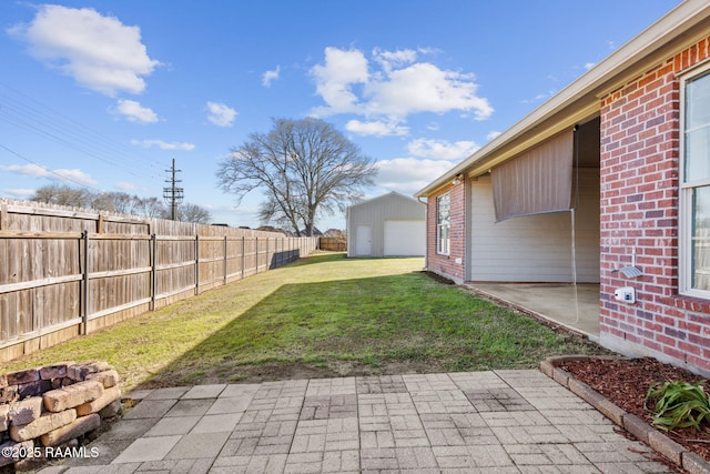 view of yard with an outdoor fire pit, a fenced backyard, an outbuilding, and a patio