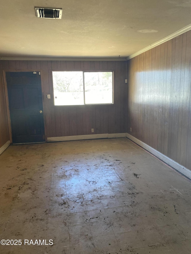 foyer with ornamental molding, visible vents, and tile patterned floors