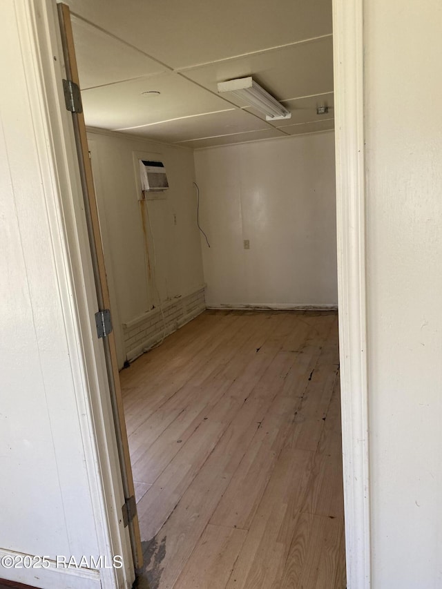 interior space featuring wood finished floors and a wall mounted AC