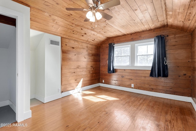 bonus room featuring baseboards, visible vents, vaulted ceiling, wooden ceiling, and light wood-type flooring