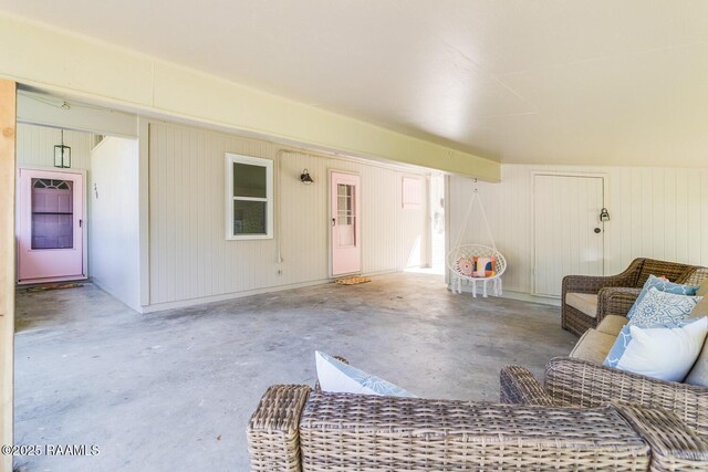 unfurnished living room featuring unfinished concrete floors