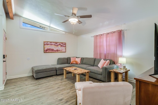 living area featuring a ceiling fan, baseboards, vaulted ceiling, visible vents, and light wood-style floors