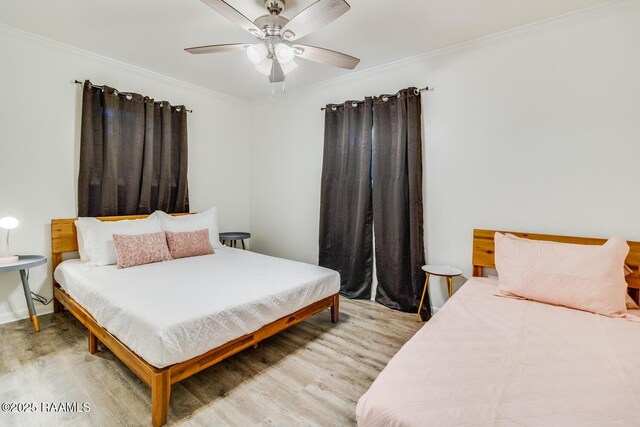 bedroom featuring ornamental molding, ceiling fan, and wood finished floors