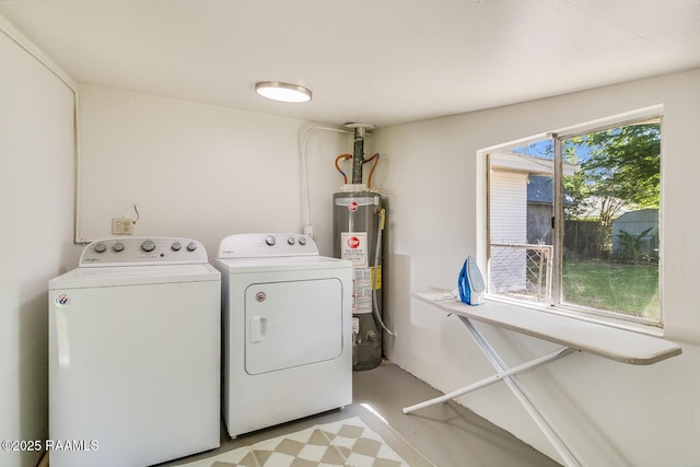 clothes washing area with light floors, laundry area, washing machine and clothes dryer, and gas water heater
