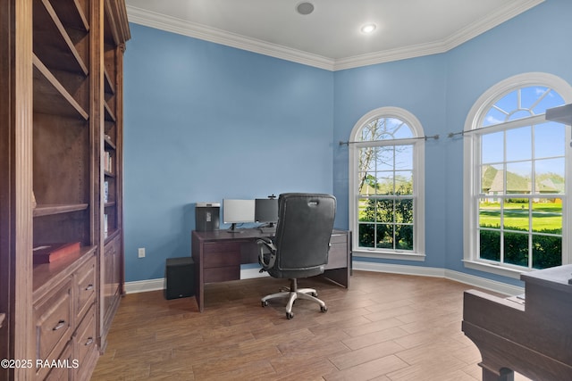 office area with baseboards, wood finished floors, and crown molding