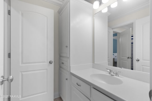 bathroom with ornamental molding and vanity