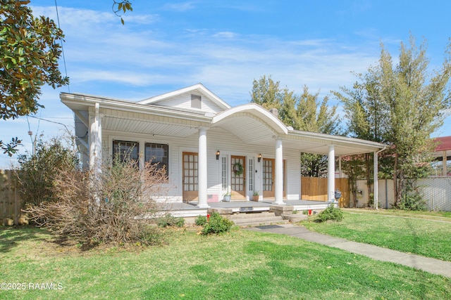 view of front facade with a porch, fence, and a front lawn