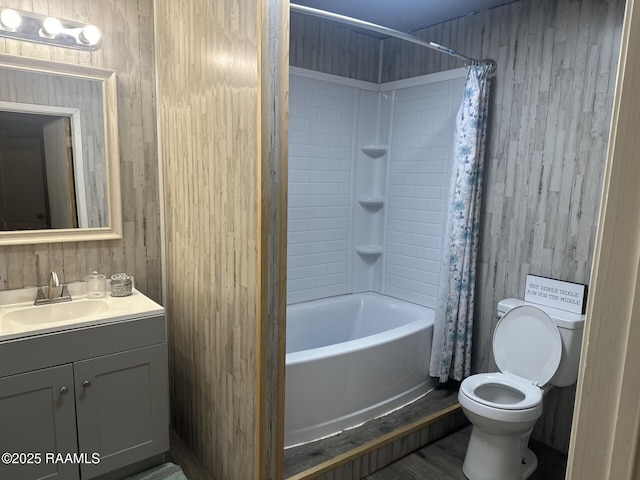 bathroom featuring toilet, shower / bath combination with curtain, and vanity