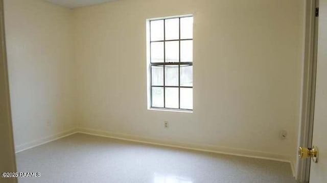 spare room featuring baseboards