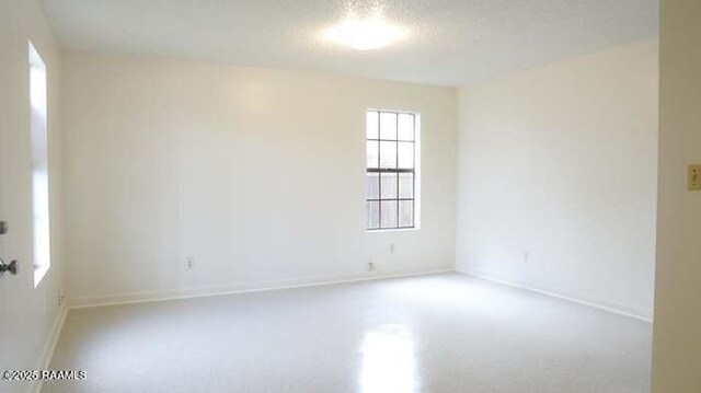 unfurnished room with baseboards