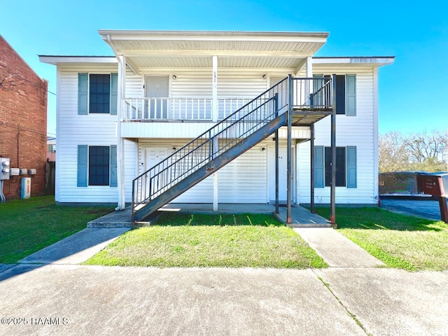 view of front of home featuring stairs, a porch, and a front yard